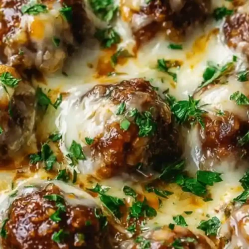 Juicy French onion meatballs baked in rich sauce with melted cheese and parsley