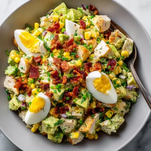Bowl of Avocado Chicken Salad with fresh ingredients and vibrant colors