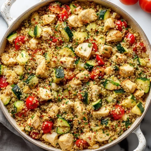 Chicken Quinoa Skillet dish with fresh vegetables in a frying pan