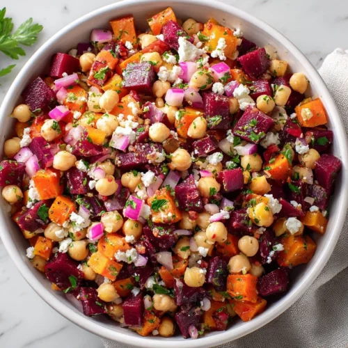 Chickpea Salad with beets, feta cheese, and lemon garlic vinaigrette served in a bowl