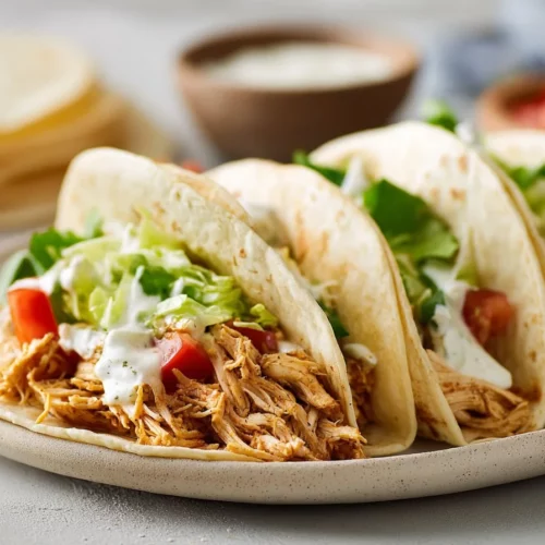 Crockpot Ranch Chicken Tacos served with toppings and fresh ingredients
