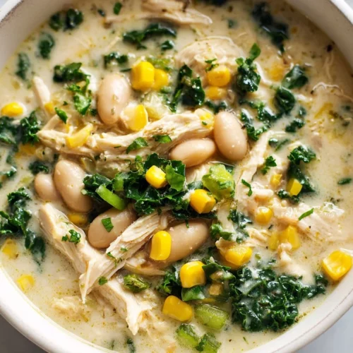Bowl of healthy Instant Pot white chicken chili garnished with cilantro and lime.