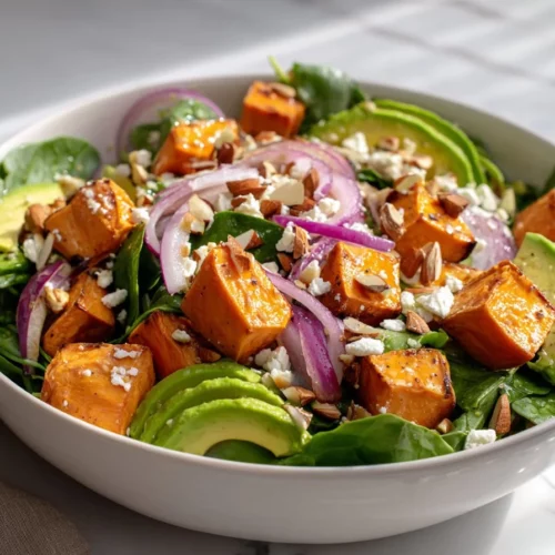 Roasted sweet potato salad with avocado and feta served in a bowl