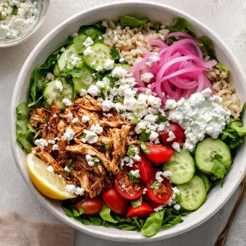Shredded Harissa Chicken Bowl with fresh vegetables and grains
