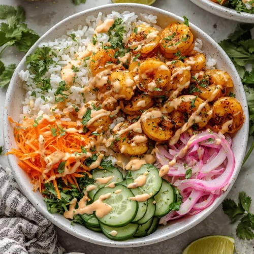 Shrimp rice bowls topped with spicy mayo on a plate